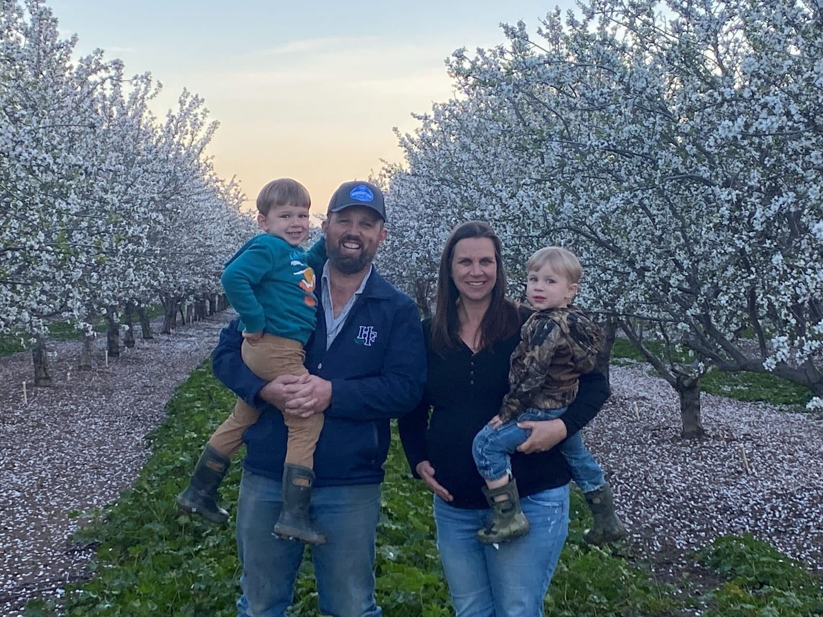 Wesley Henderson and his family in their almond orchard at bloom